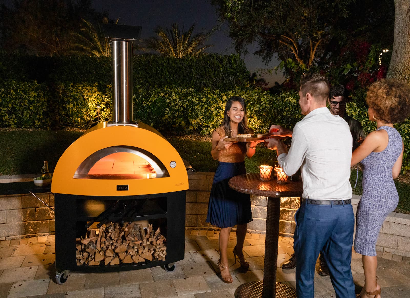 Domestic pizza oven in a garden with friends
