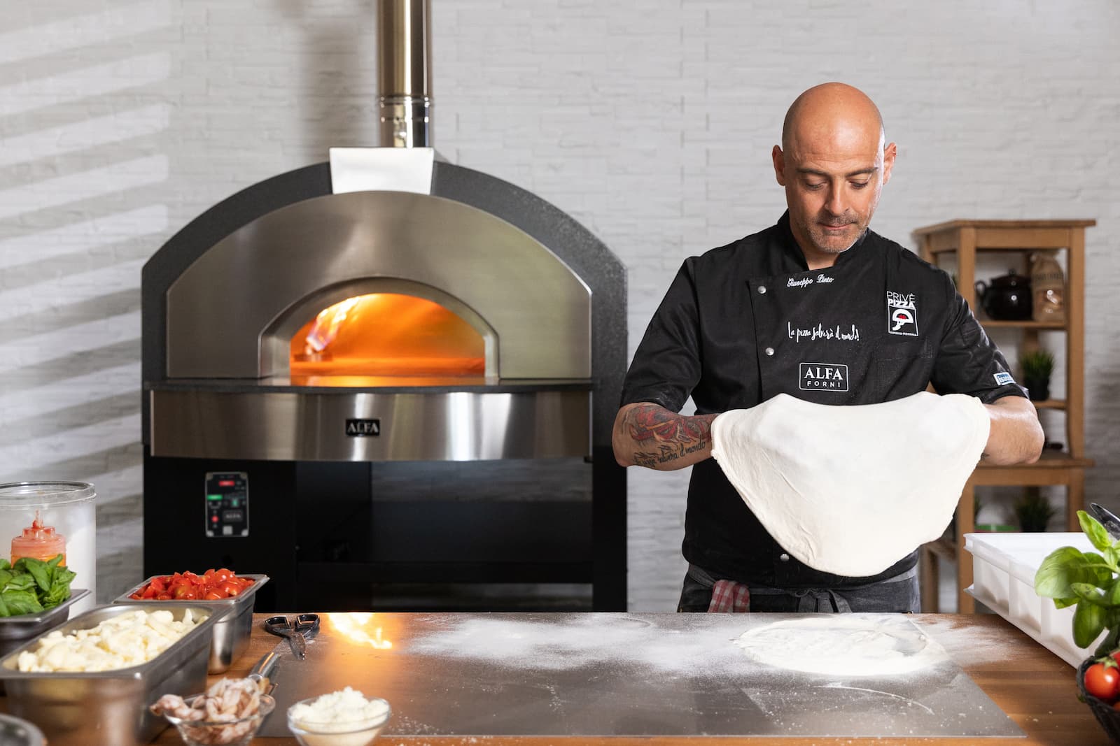 Commercial pizza oven with chef preparing dough