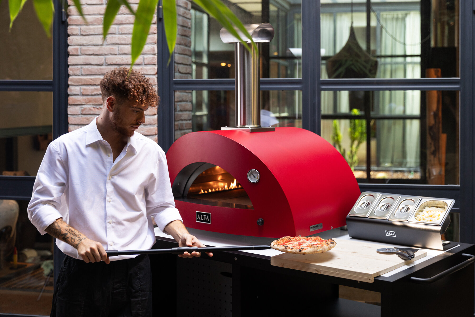 Chef serving pizza from Cooking Station with peel